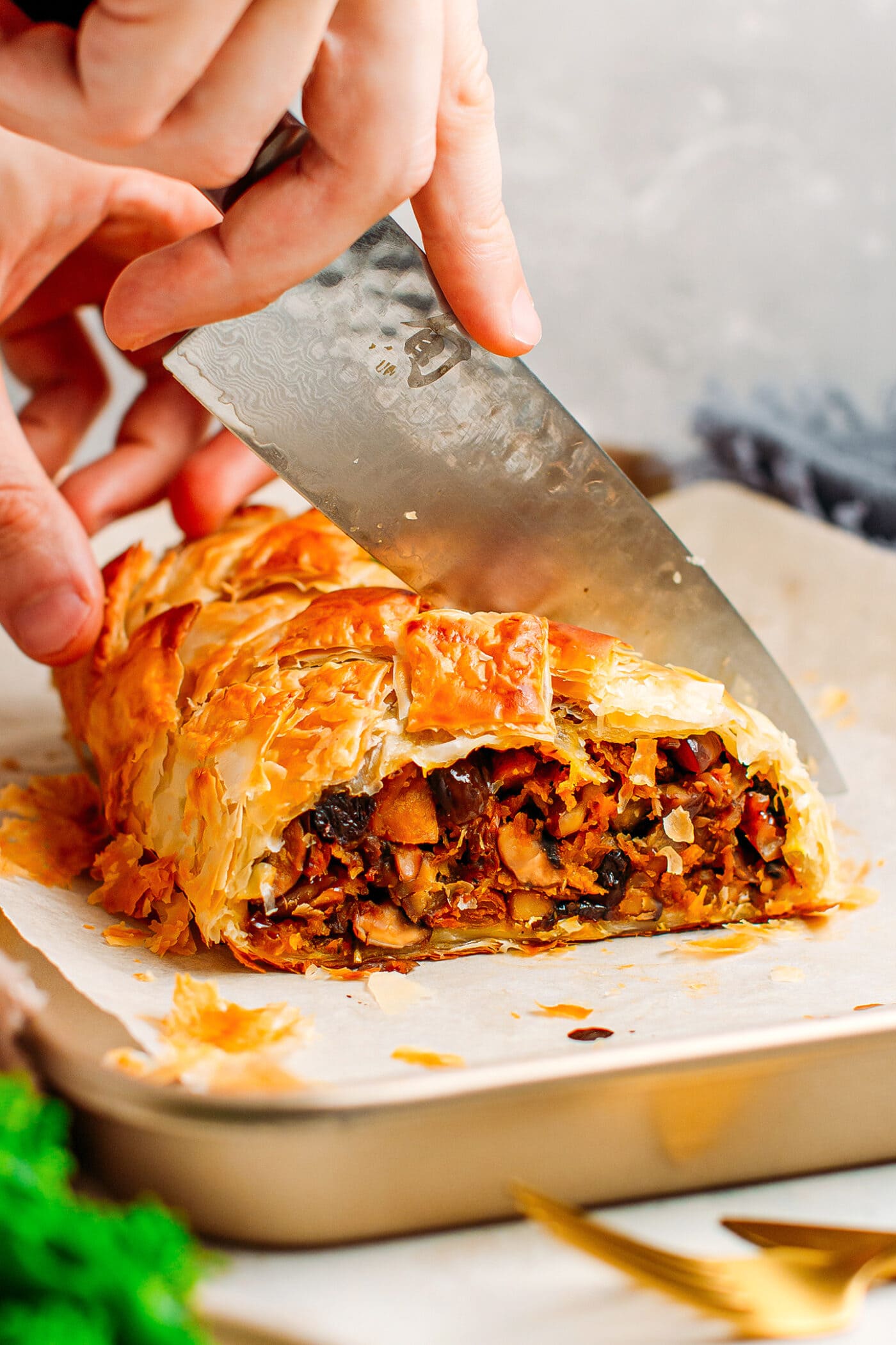 Cutting through a vegan Wellington loaf.