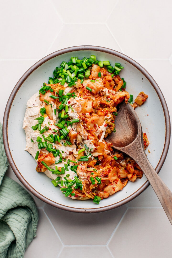 Stirring kimchi, green onions, and tofu cream.