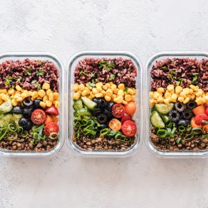 A photo of three containers filled with sweetcorn, fruits, legumes, wholegrains & vegetables