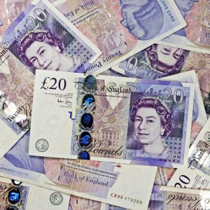 Several £20 notes laid out on a table