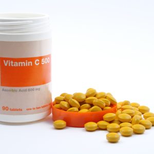 A photo of vitamin c tablets next to their packaging which reads 'Vitamin C'