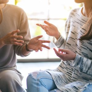 A photo of two people talking