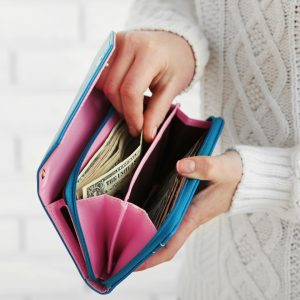 A photo of someone getting money out of their purse