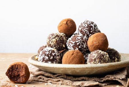 A photo of the truffles assembled on a plate, coated in dessicated coconut and cocoa powder