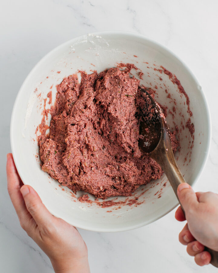 Mixing mushroom paste with flour and vital wheat gluten in a bowl.