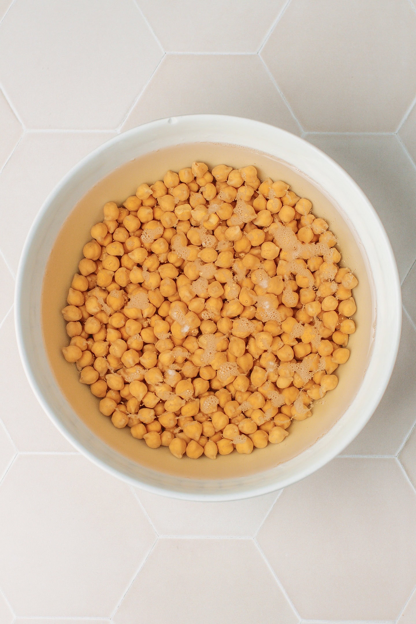 Soaked chickpeas in a large bowl.