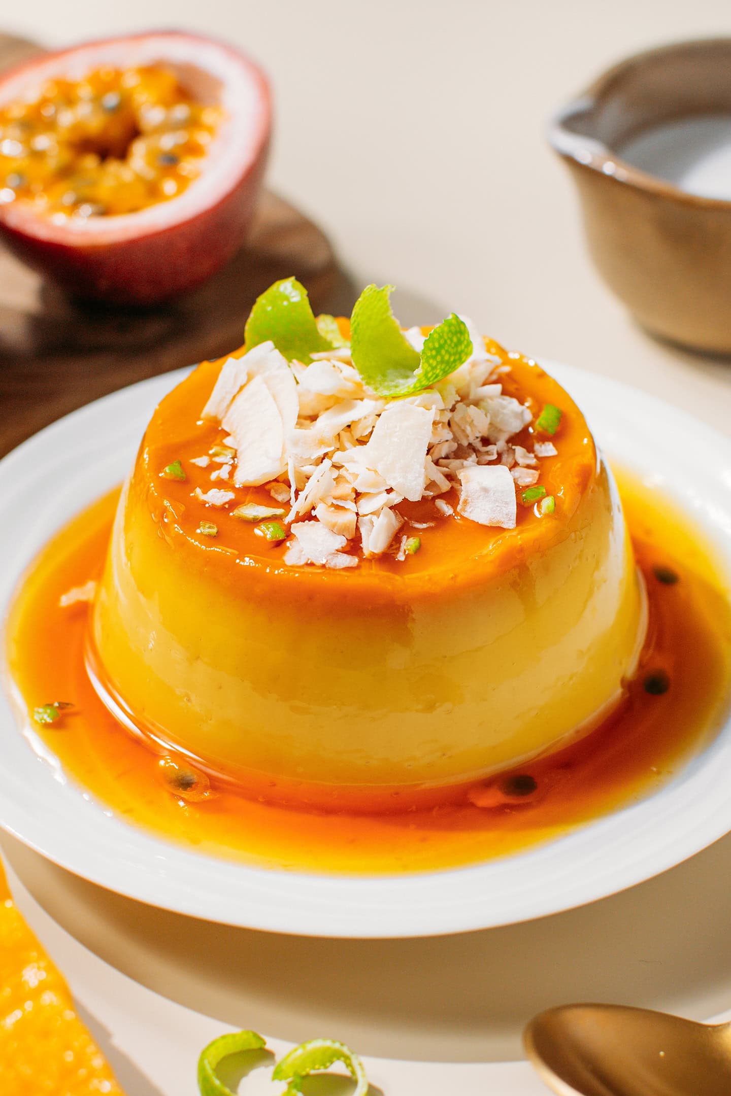 Mango and passion fruit flan topped with coconut flakes and lime zest.