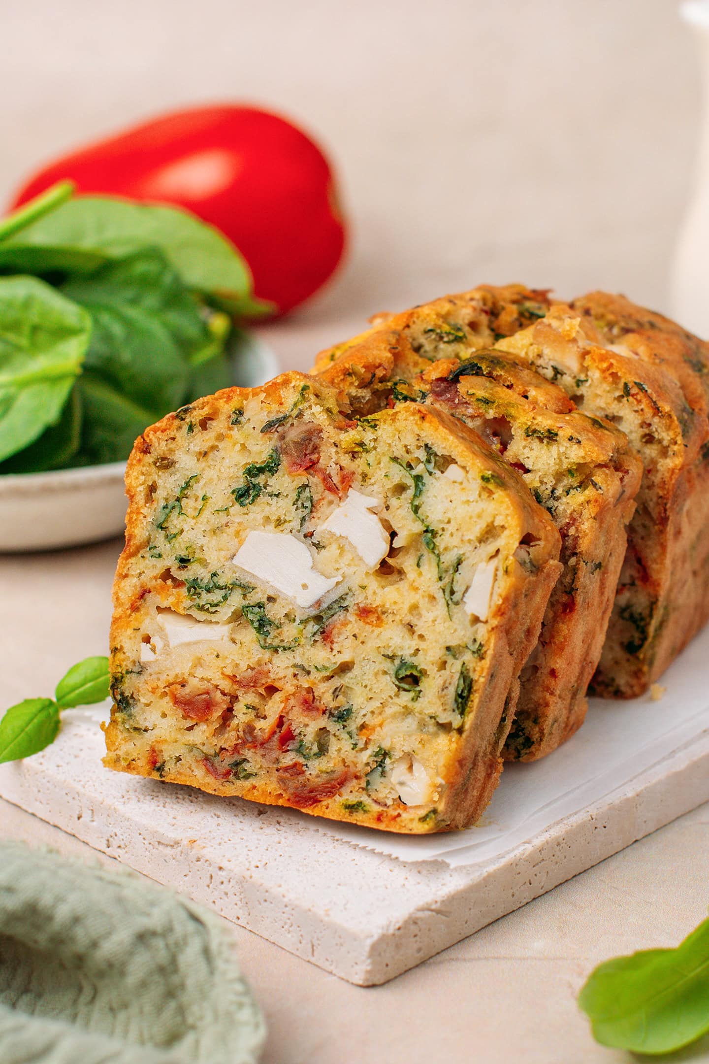 Sliced vegan savory loaf cake on a white plate.