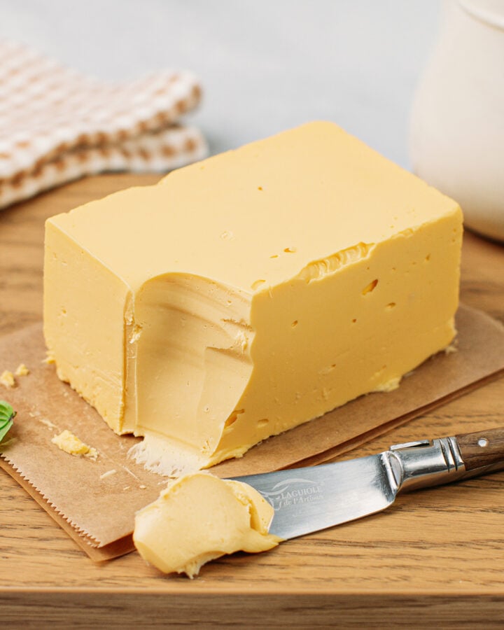 Block of vegan butter on a wood cutting board.