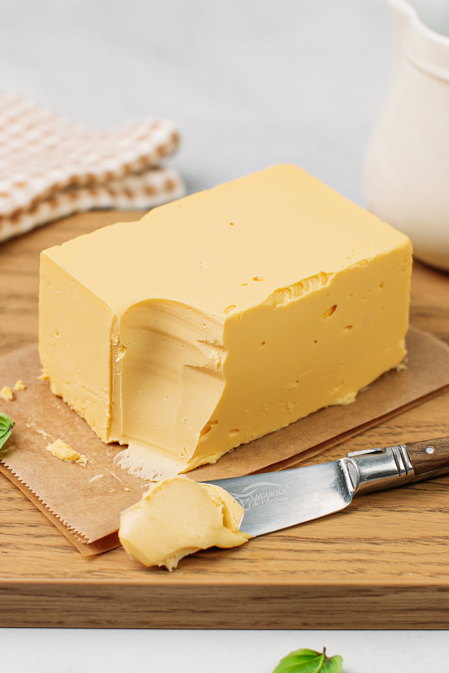 Block of vegan butter on a wood cutting board.