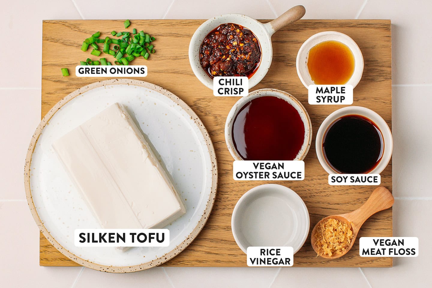 Ingredients like silken tofu, vegan oyster sauce, soy sauce, and chili crisp.